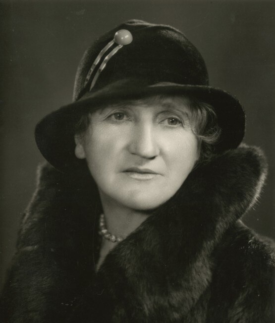 a woman in a fur coat and cloche hat