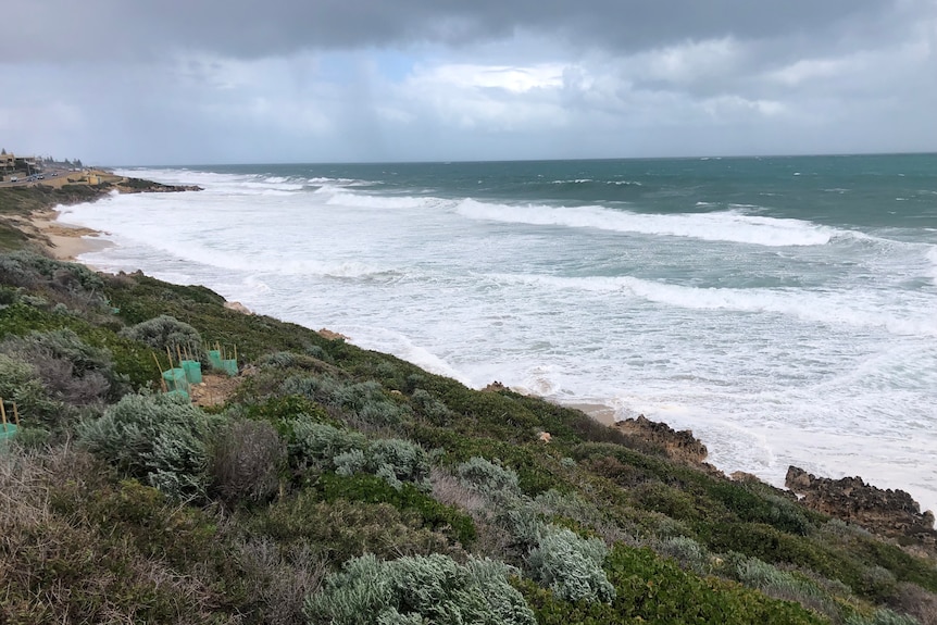 Powerful swells cause waves to swallow most of the sand at North Beach