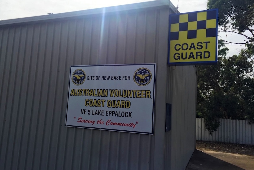 The side of a shed with a sign saying Coast Guard and Australian Volunteer Coast Guard