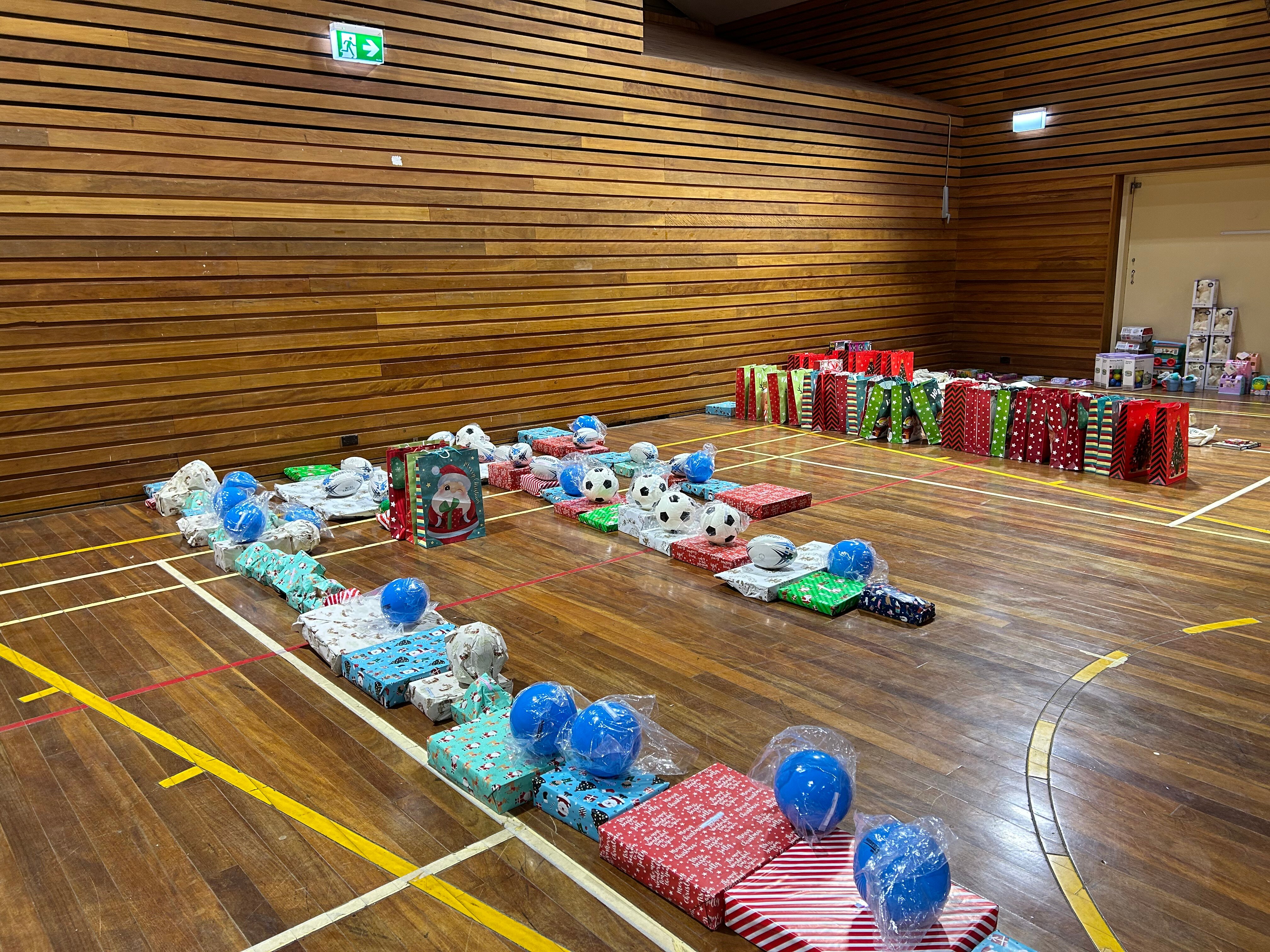 presents are laid out on an indoor basketball court.