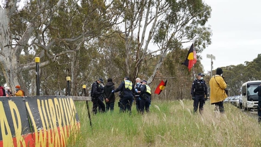 Police and signs at the protest camps on the Western Highway.