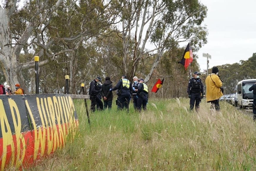 Police and signs at the protest camps on the Western Highway.