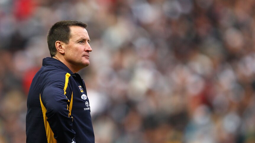 Then-Eagles coach John Worsfold watches West Coast lose to Collingwood in the 2011 AFL finals.