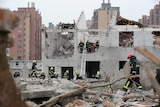 Rescue workers stand in the rubble of a building after a blast in Ningbo, China.