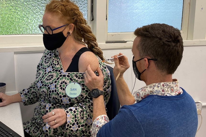 The doctor on Lord Howe Island getting her Pfizer jab from her nurse husband