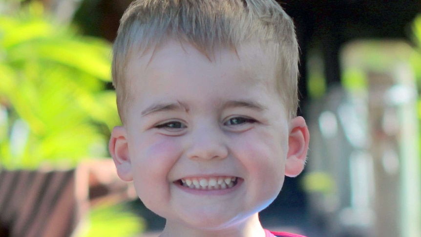 A boy in a Superman costume