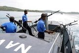 Sri Lankan Navy sailors man their guns as they patrol on a boat in Trincomalee.