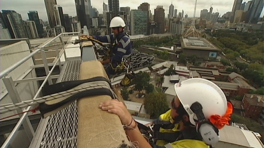 Workers abseiling from building