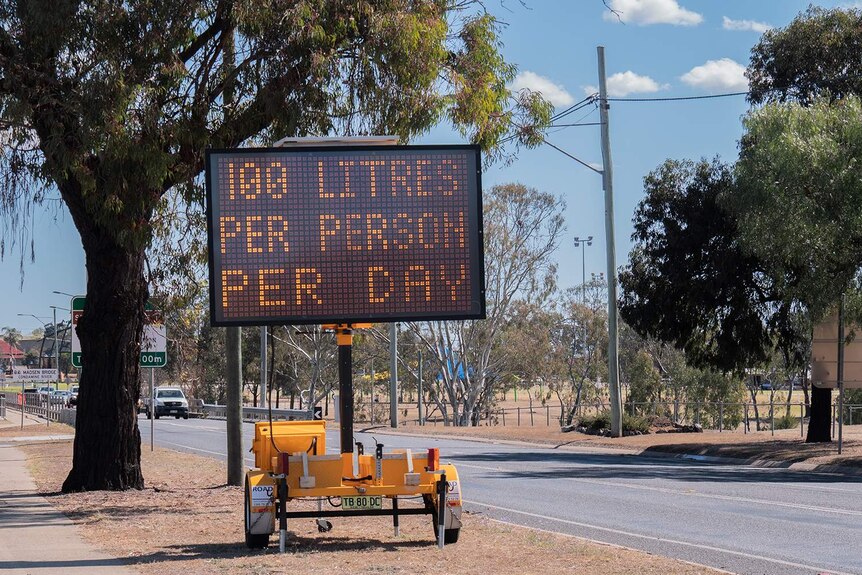 A roadside sign reads 100 litres a day
