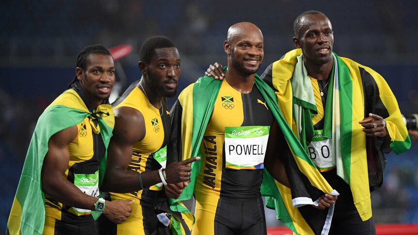 The Jamaican team celebrates winning the 4x100m final