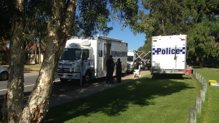 Police at the Atwell property where Jamie Devine was stabbed during a brawl at a party.