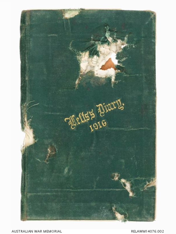 A tattered pocketbook with damage to the cover, possibly a bullet hole