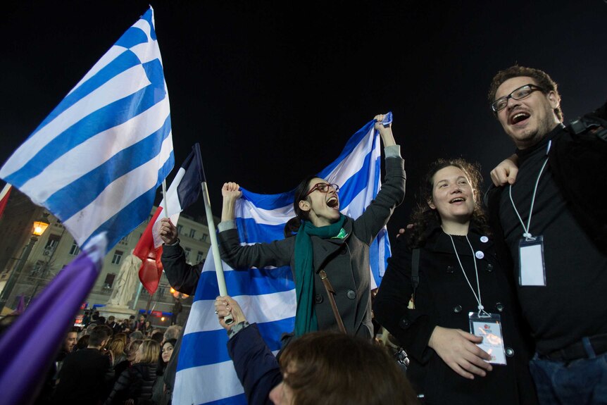 Supporters of the Syriza Party wave Greek flags