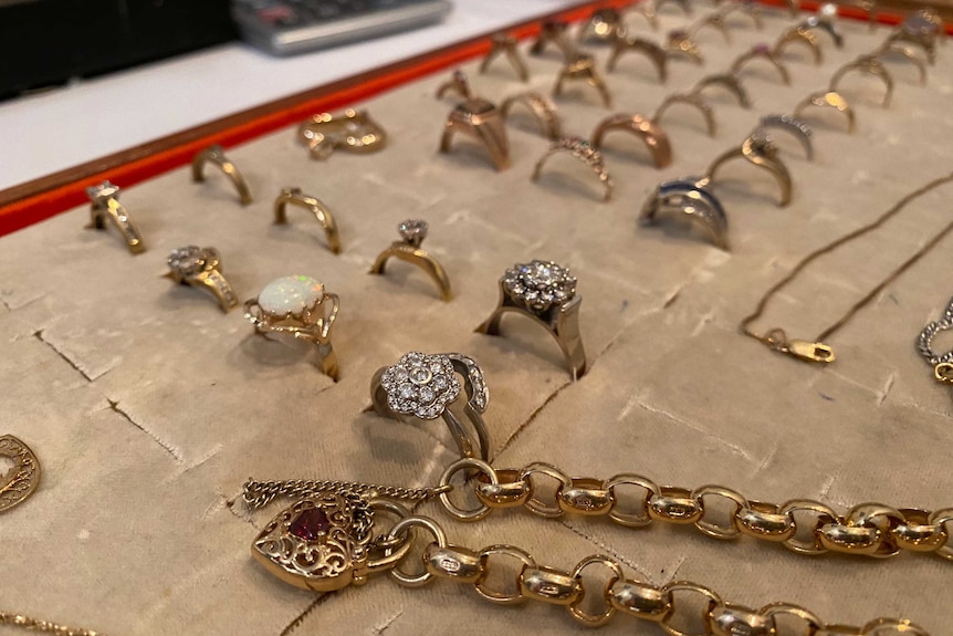 Jewellery and rings spread out on a board on display