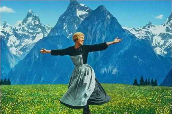 A woman dances in front of the Swiss Alps.