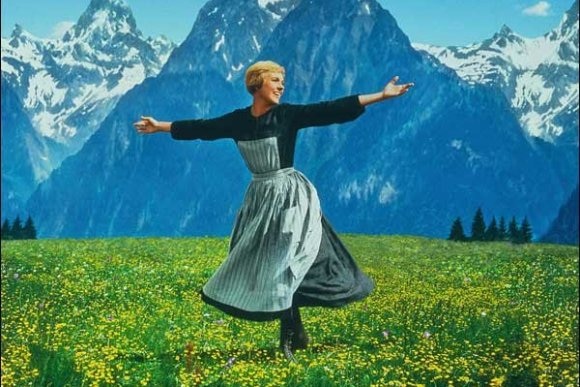 A woman dances in front of the Swiss Alps.