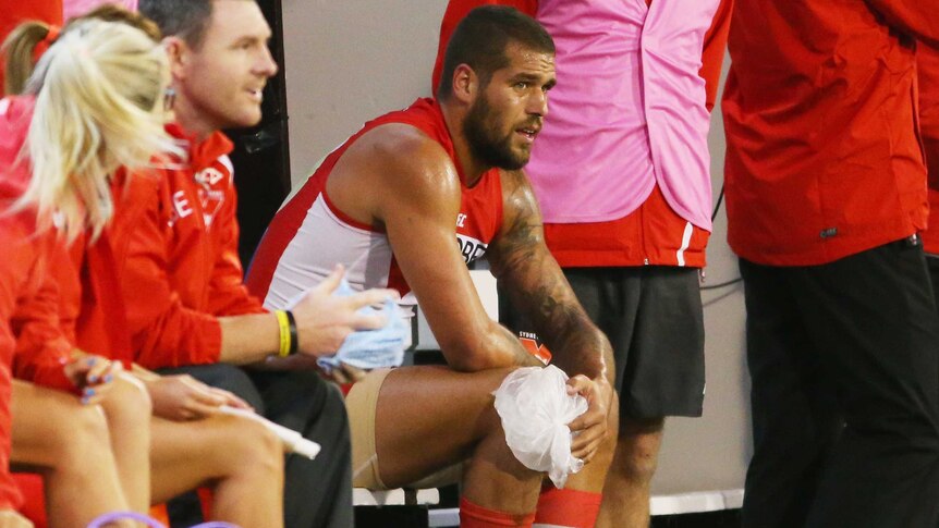 Lance Franklin sits on the bench with ice on his knee during Sydney's match with Melbourne