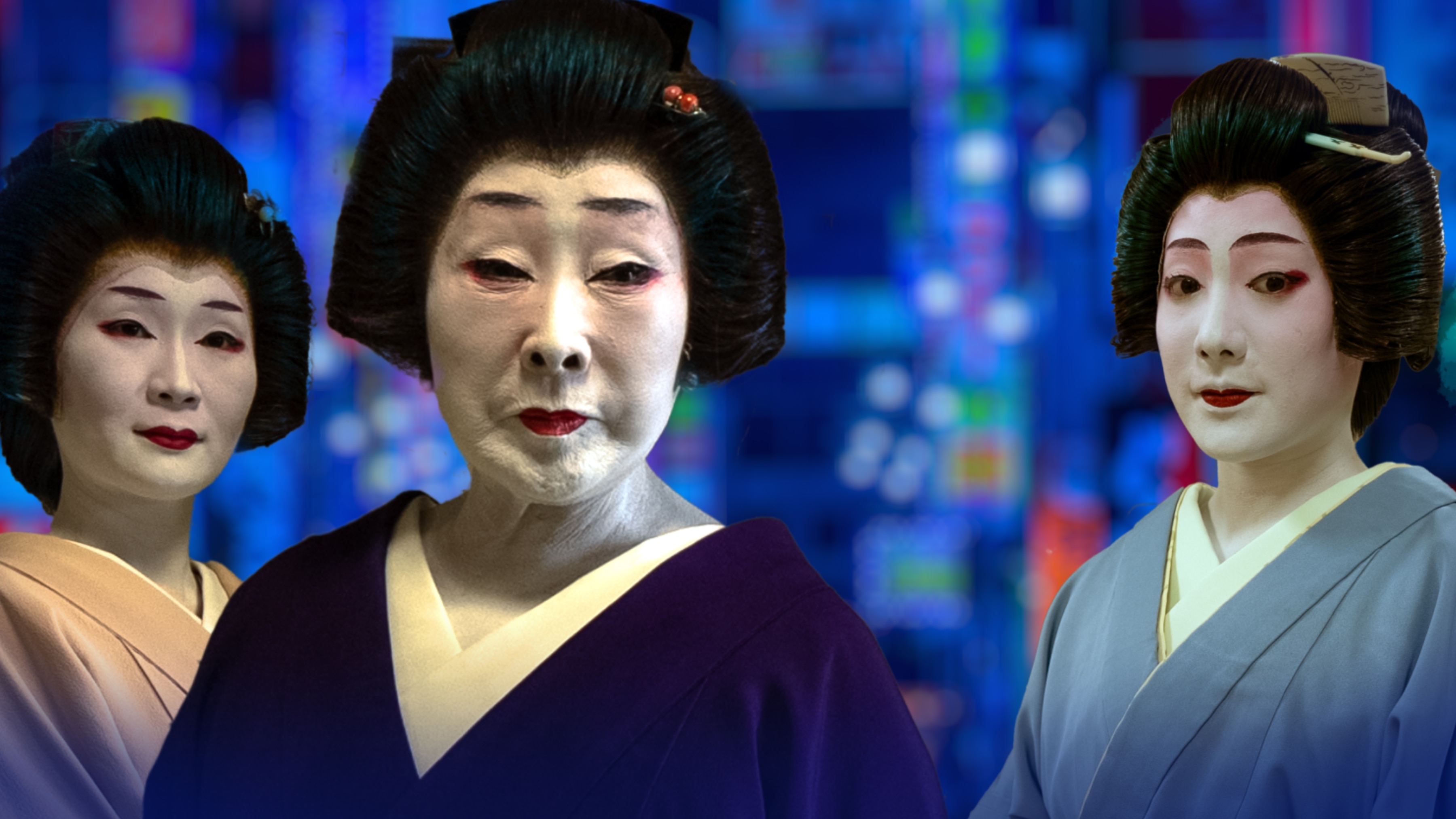 Three geishas wear traditional robes, hair and makeup