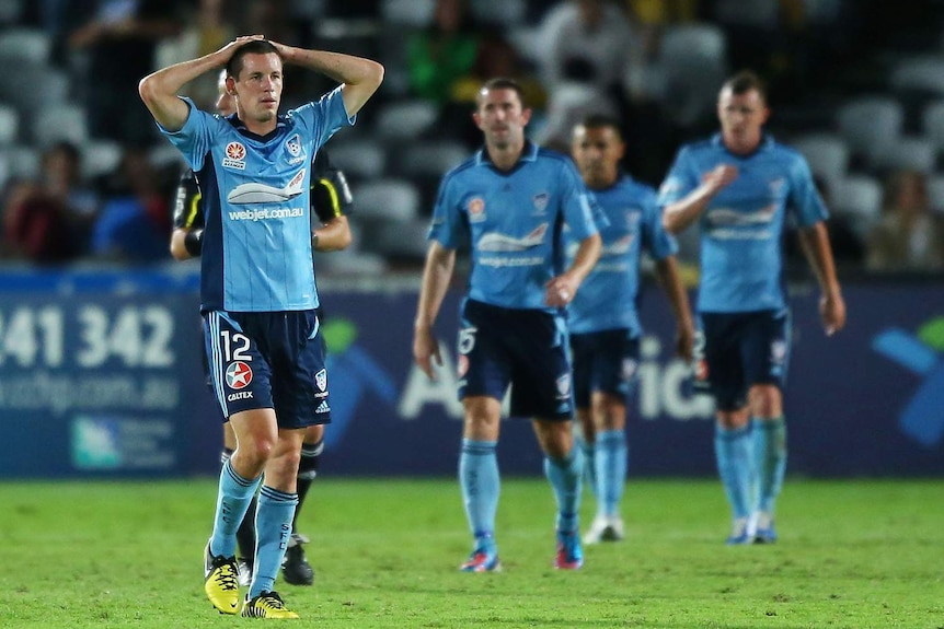 Dejected ... Sydney FC players react after the final whistle at Gosford.
