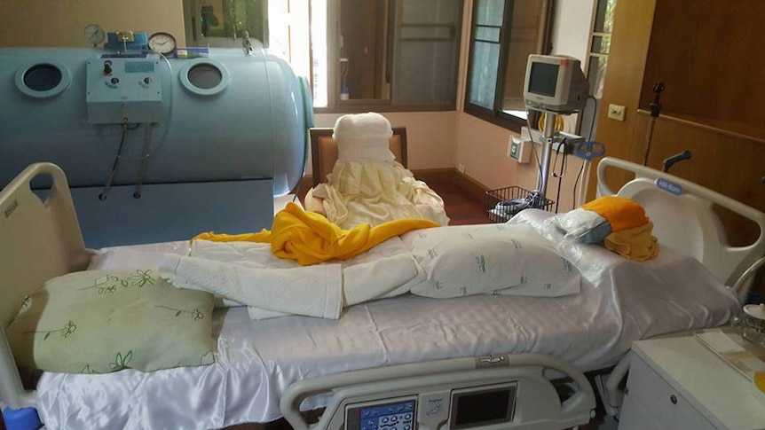 Pillows and blankets are arranged on a bed previously used by fugitive Thai monk Phra Dhammachayo to make a human form.
