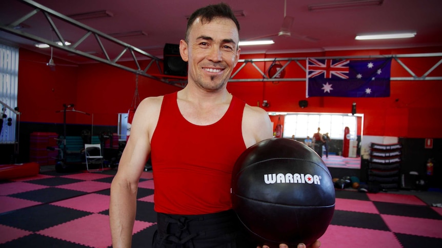 Hassan Haidary holds a medicine ball