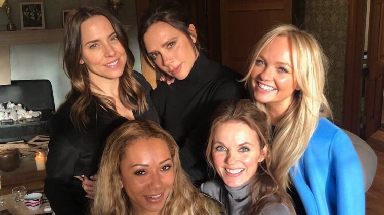 The five members of the Spice Girls pose for a photo together. No, Posh isn't smiling.