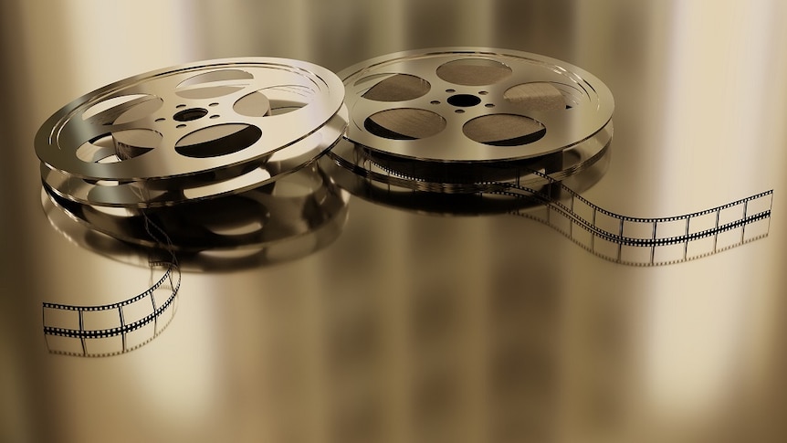 a picture of two film reels with the film exposed