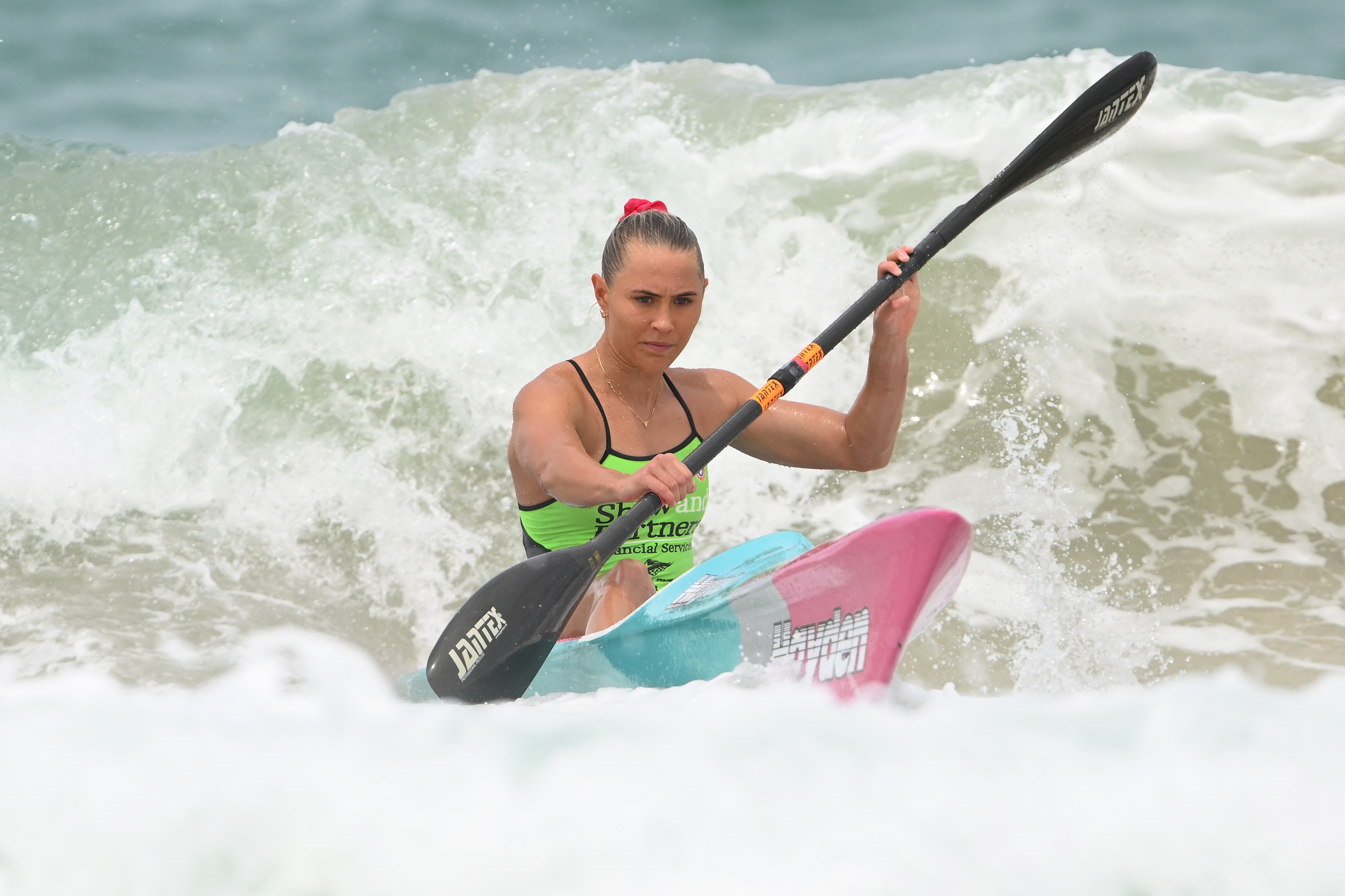 Tiarnee Massie on the ski in water, wears a green jersey.