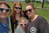 Four women and girls wearing sunglasses