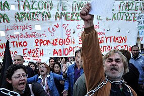 Demonstrators shout slogans against the government's austerity measures during a protest outside the Greek Parliament in Athe...