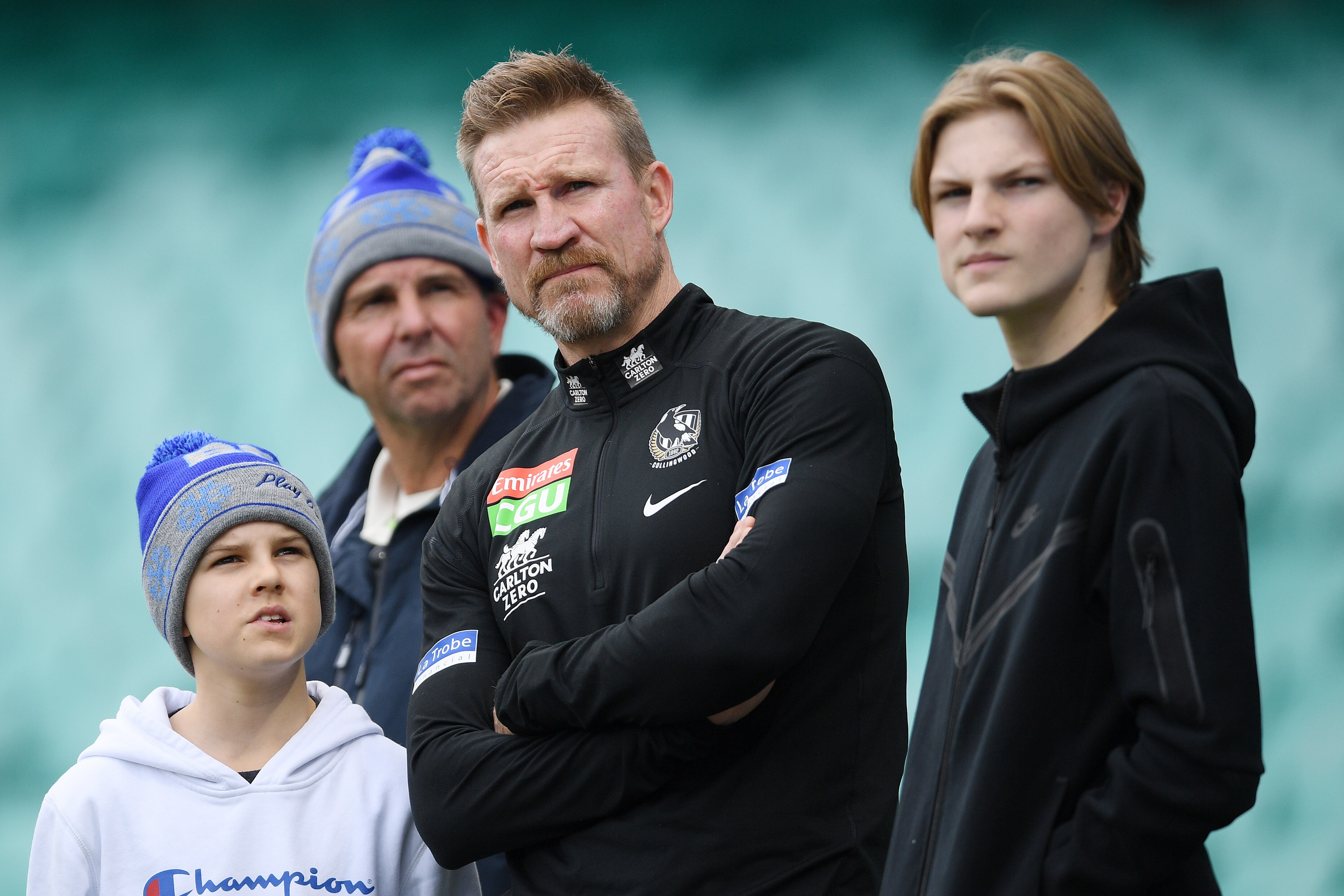 The Collingwood AFL coach pictured standing with his two sons at the SCG.