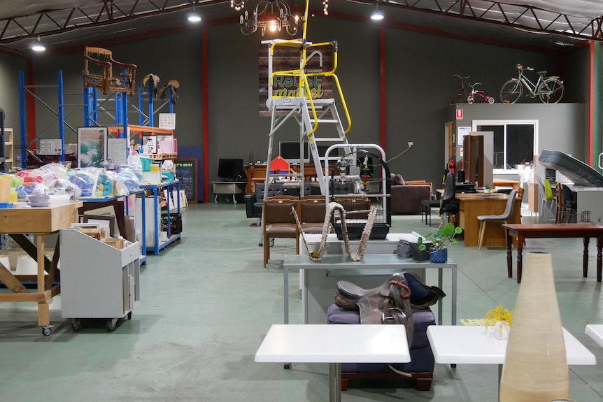 Wide-shot of a upcycling centre with random salvaged goods