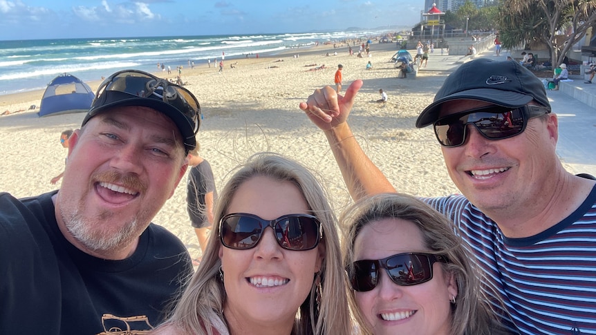 Four people at the beach.