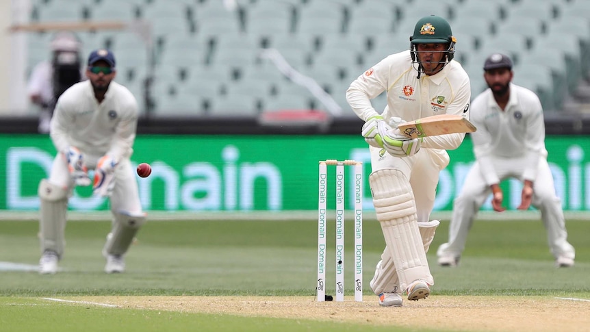 Usman Khawaja watches the ball after playing a shot