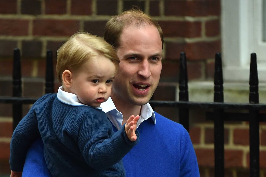 Prince William carries his son Prince George to the Lindo Wing at St Mary's Hospital in central London