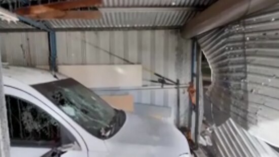 A dented garage wall where a bomb has gone off