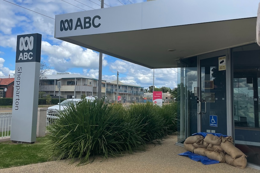 Exterior of ABC office with sand bags at front door.