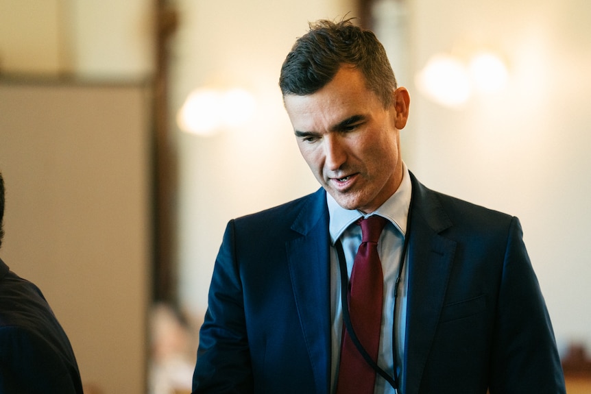 A mid-shot of state Perth MP John Carey looking downwards.