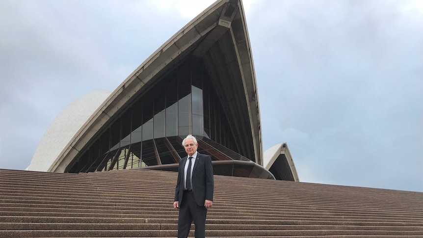 Steve Tsoukalas stands on the steps of the Sydney Opera House