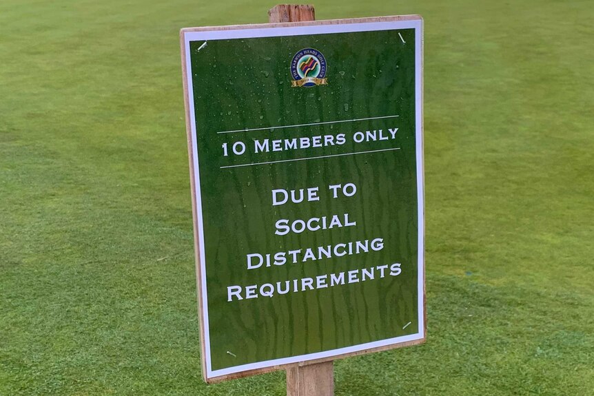 A sign on a golf fairway saying 10 members only due to social distancing requirements.