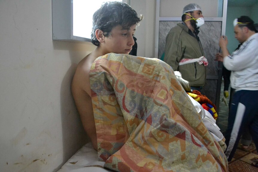 A young man recovers from what is believed to be a chlorine gas attack in the village of Sarmin in Syria's north-western province of Idlib.