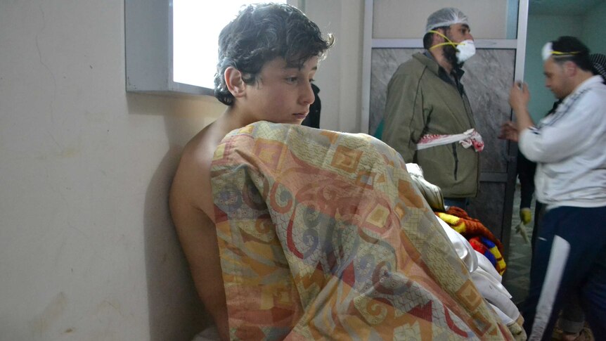 A young man recovers from what is believed to be a chlorine gas attack in the village of Sarmin in Syria's north-western province of Idlib.