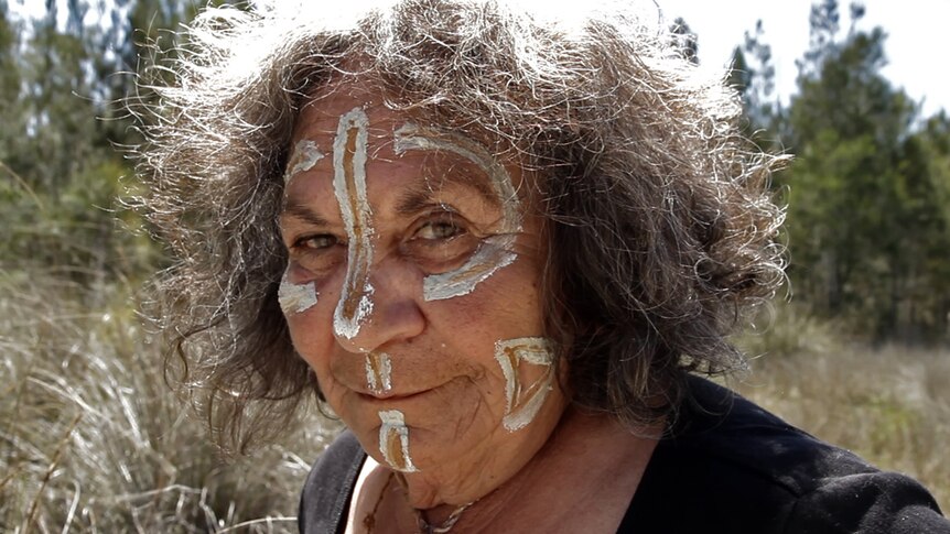 Indigenous woman in traditional facepaint