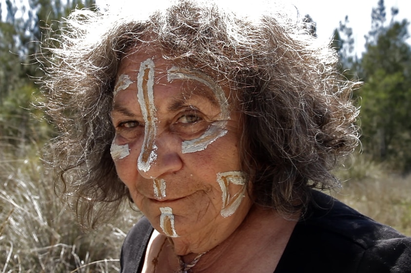 Indigenous woman in traditional facepaint