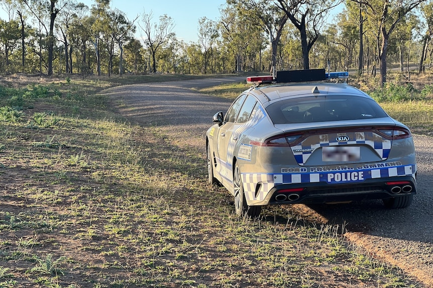 A police car on a dirt road