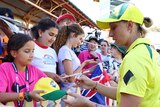 Australia cricketer Ash Gardner signs autographs for young girls in the crowd after a T20 against Pakistan.