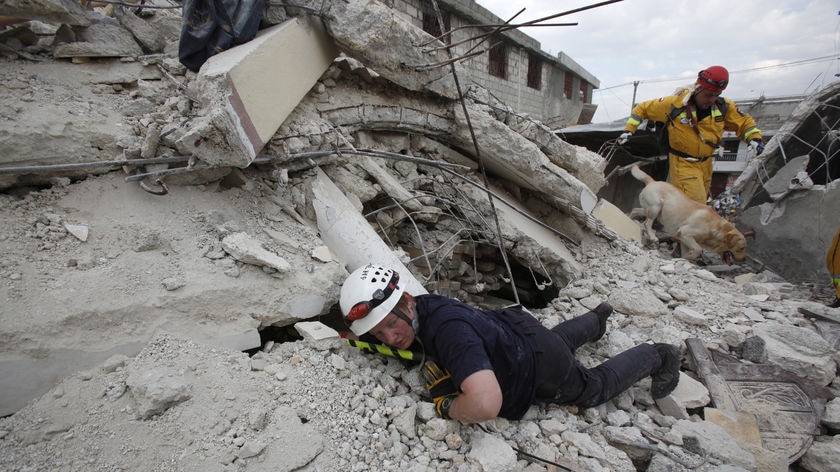 Search crew try to find earthquake survivors in Port-au-Prince