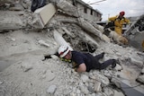 Search crew try to find earthquake survivors in Port-au-Prince