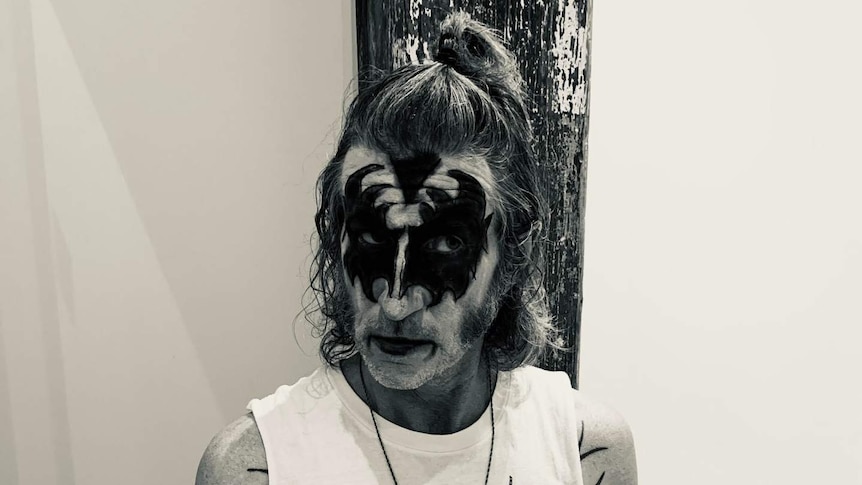 You Am I frontman Tim Rogers poses while wearing the stage face paint of Kiss bass player Gene Simmons