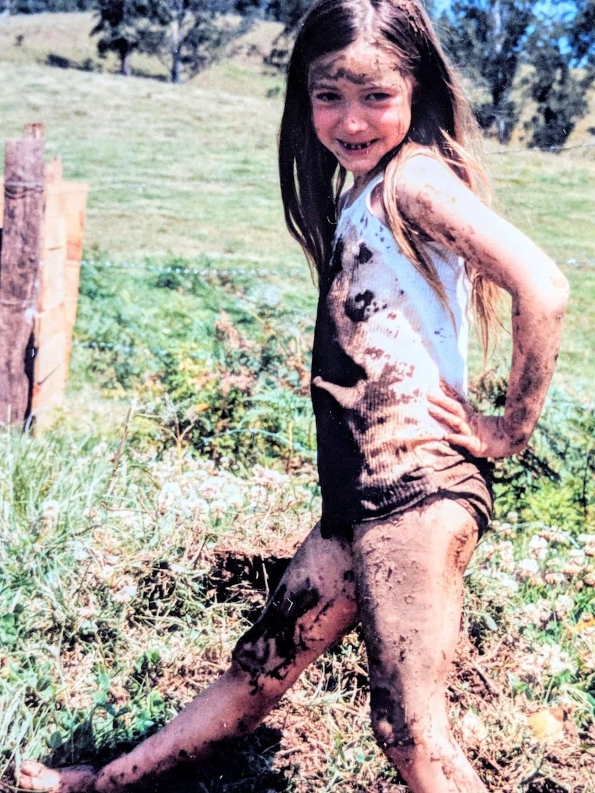 A young girl bending her leg against the ground